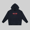 A dark navy blue pullover hoodie with a front kangaroo pocket and a small chest graphic showing three red and white football jerseys. The hoodie is displayed flat against a solid light gray background.