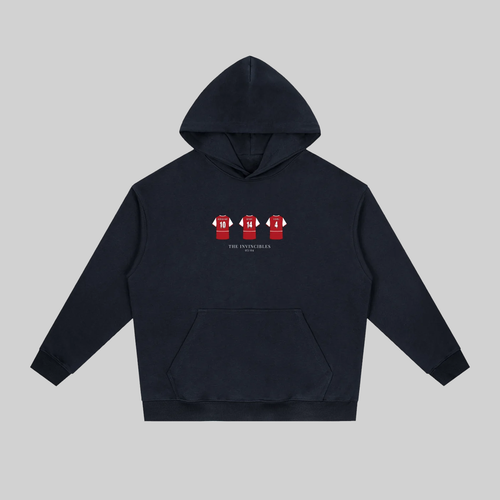 A dark navy blue pullover hoodie with a front kangaroo pocket and a small chest graphic showing three red and white football jerseys. The hoodie is displayed flat against a solid light gray background.