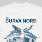White crewneck t-shirt featuring a blue graphic print that reads 'the CURVA NORD' above a stylized illustration of a curved stadium, shown on a neutral gray background.