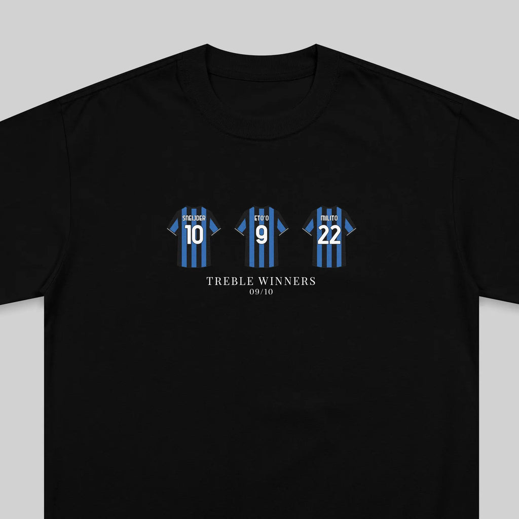 A black short-sleeve t-shirt with a graphic print of three blue and black striped soccer jerseys numbered 10, 9, and 22, with the text 'TREBLE WINNERS' and '09/10' printed below.