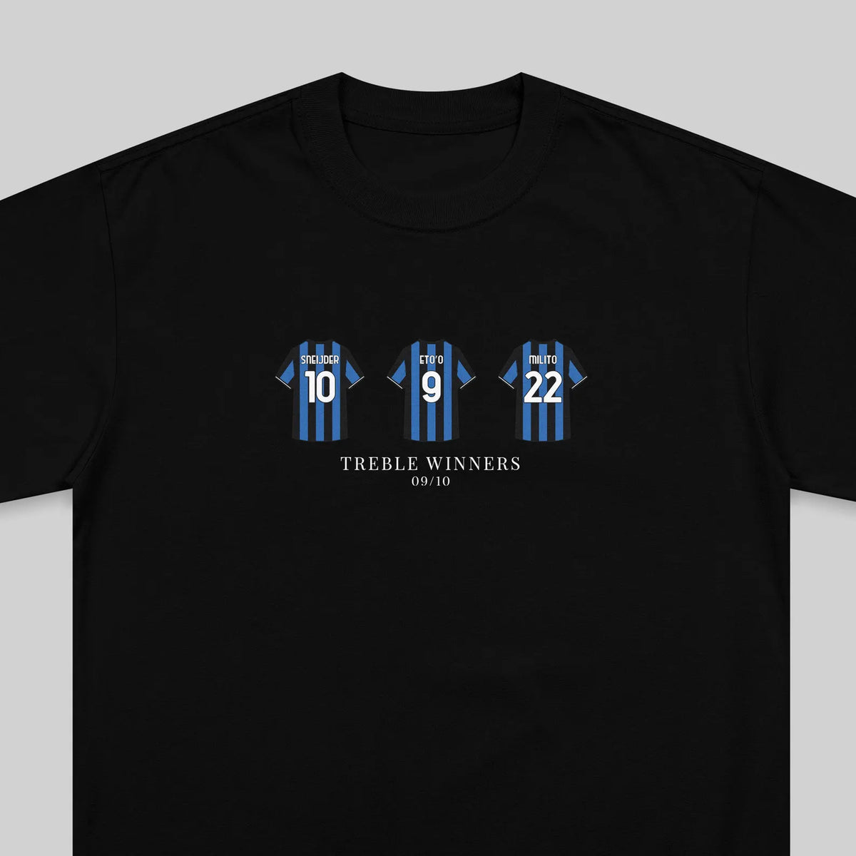 A black short-sleeve t-shirt with a graphic print of three blue and black striped soccer jerseys numbered 10, 9, and 22, with the text 'TREBLE WINNERS' and '09/10' printed below.