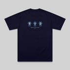 A navy blue short-sleeve t-shirt with a graphic on the chest showing three stylized blue and white figures with numbers 16, 8, and 2, and the text 'THREE WINNERS' underneath, displayed on a neutral gray background.