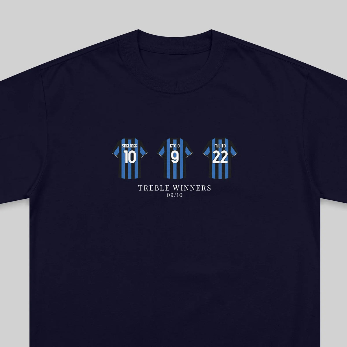 A navy blue crewneck t-shirt featuring a graphic of three blue and black striped soccer jerseys with the numbers 10, 9, and 22, above the text 'TREBLE WINNERS' and '09/10'.
