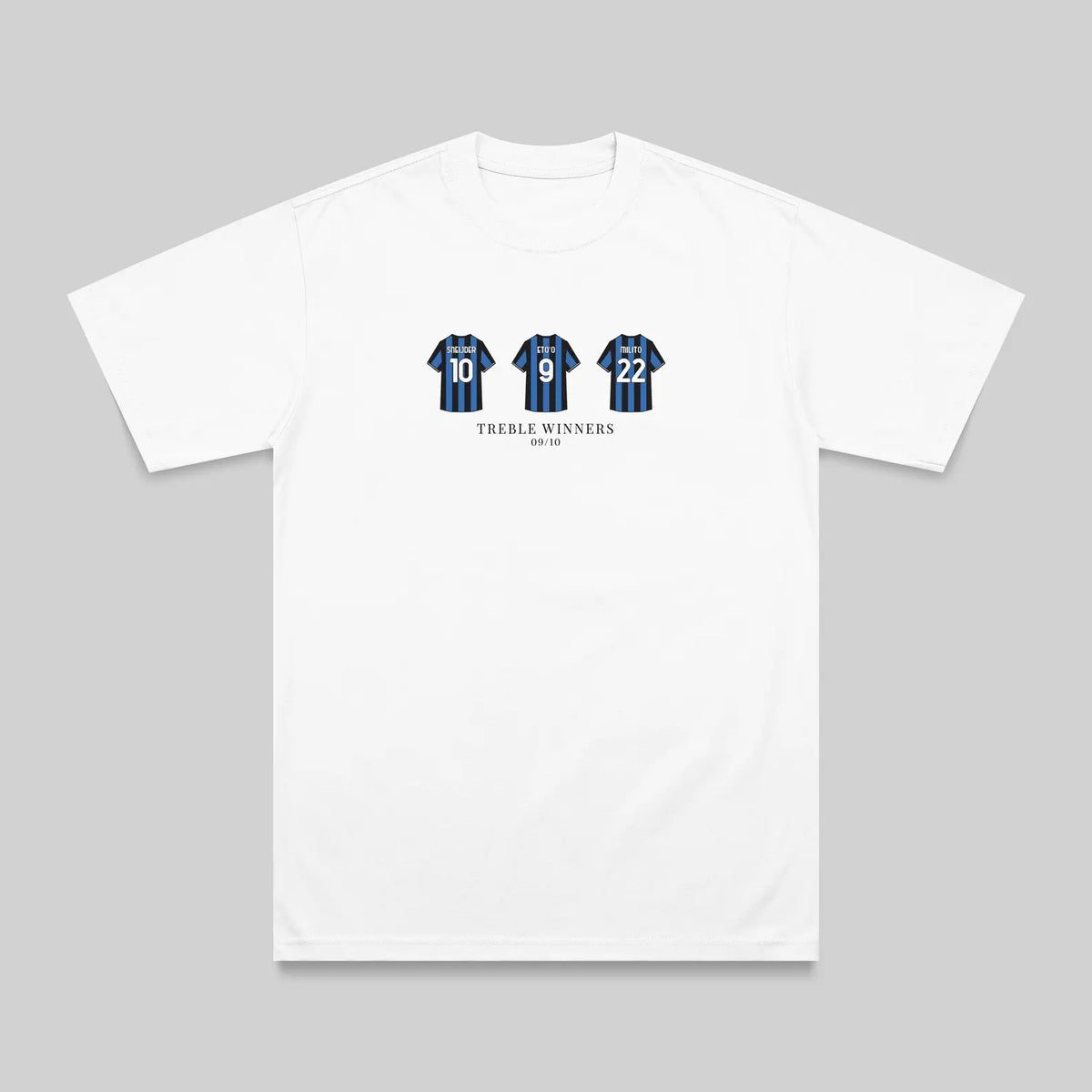 A white short-sleeve crewneck t-shirt with a graphic on the chest showing three blue and black striped jerseys with the number 15, and the text 'TREBLE WINNERS' underneath, displayed on a neutral gray background.