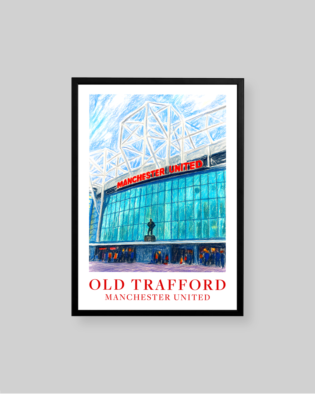 A framed art print of Old Trafford stadium in Manchester United, featuring a vibrant blue and white architectural illustration with red text, displayed on a neutral gray background.