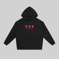 A black pullover hoodie with a front kangaroo pocket and a small chest graphic showing three red soccer jerseys with white numbers. The hoodie is displayed flat against a solid gray background.