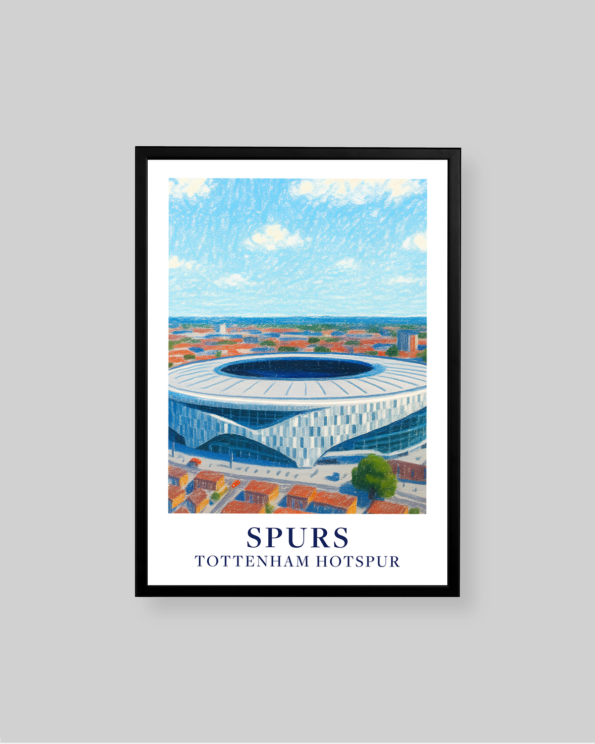 A framed sports poster of the Tottenham Hotspur stadium, featuring a blue and white illustration of the stadium under a blue sky, with the text 'SPURS' and 'TOTTENHAM HOTSPUR' at the bottom. The poster is framed in black and displayed against a neutral gray background.