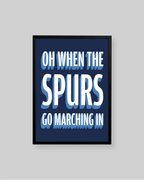 A framed typographic wall art print with the text 'OH WHEN THE SPURS GO MARCHING IN' in white and light blue lettering on a dark navy background, shown against a light gray wall.