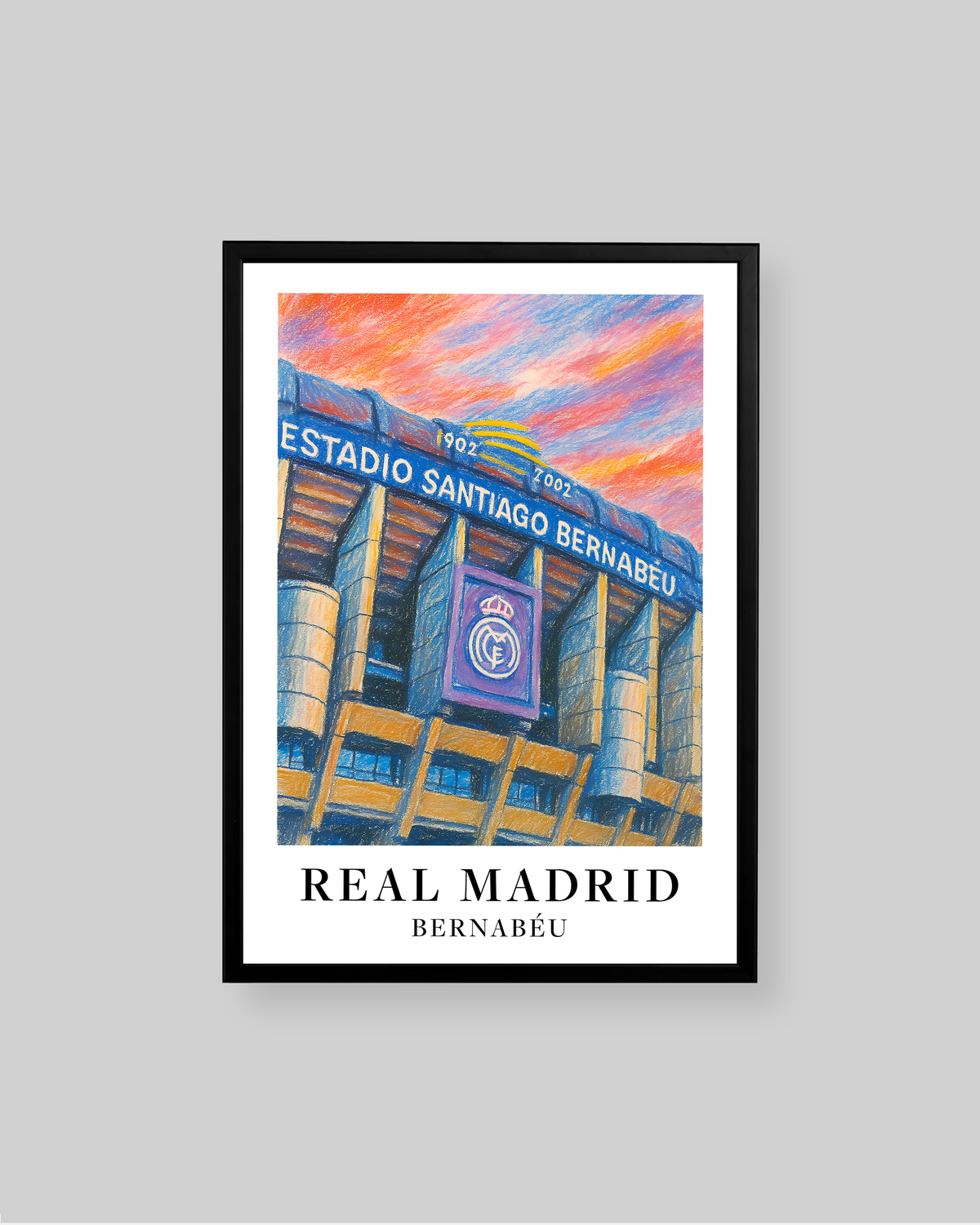 A framed art print of Real Madrid Bernabéu Stadium, featuring a colorful, textured painting of the stadium under a vibrant orange and pink sky. The print is framed in black with a white mat and displays the text 'REAL MADRID BERNABÉU' at the bottom.